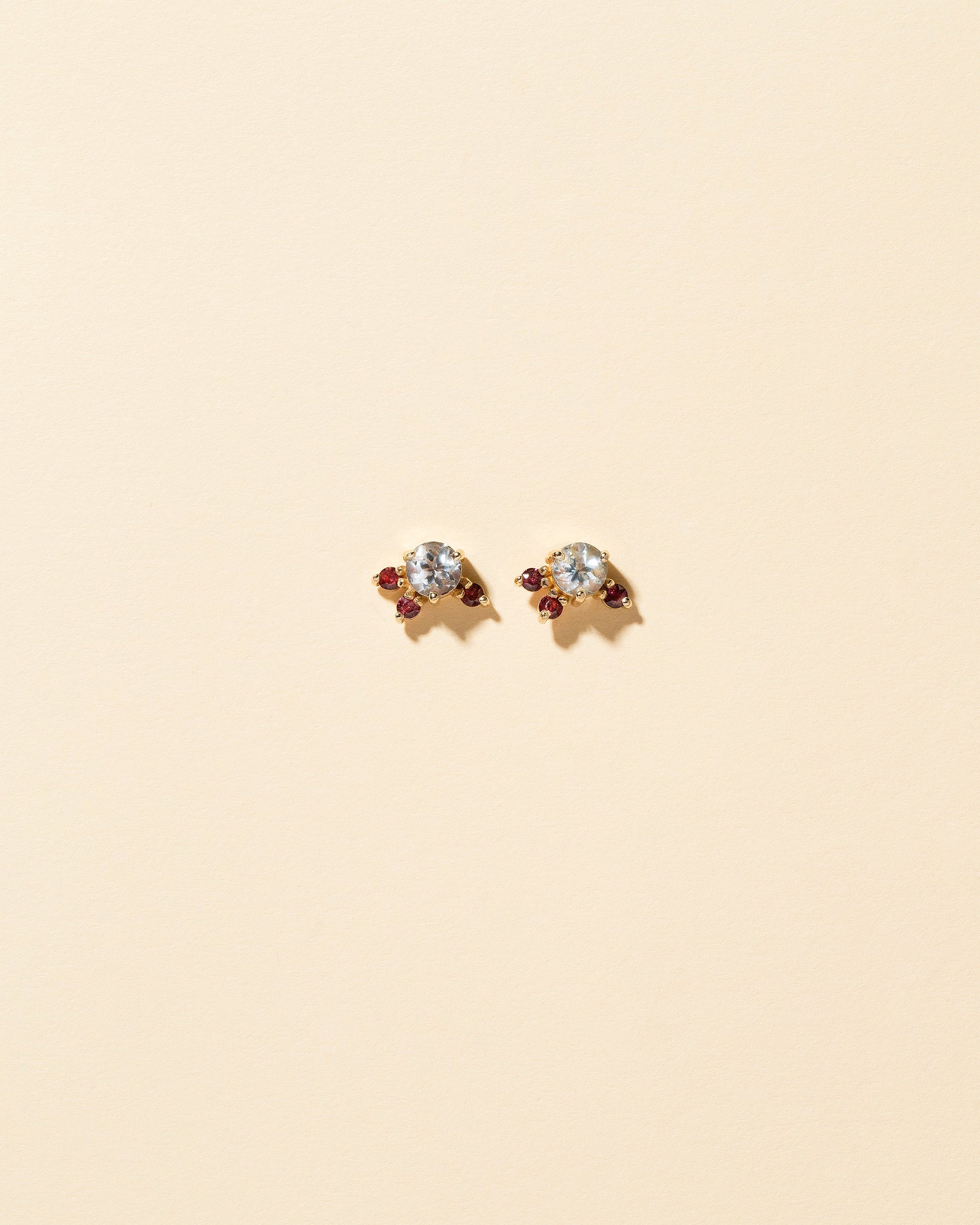 Aquamarine & Garnet Earrings on light color background.