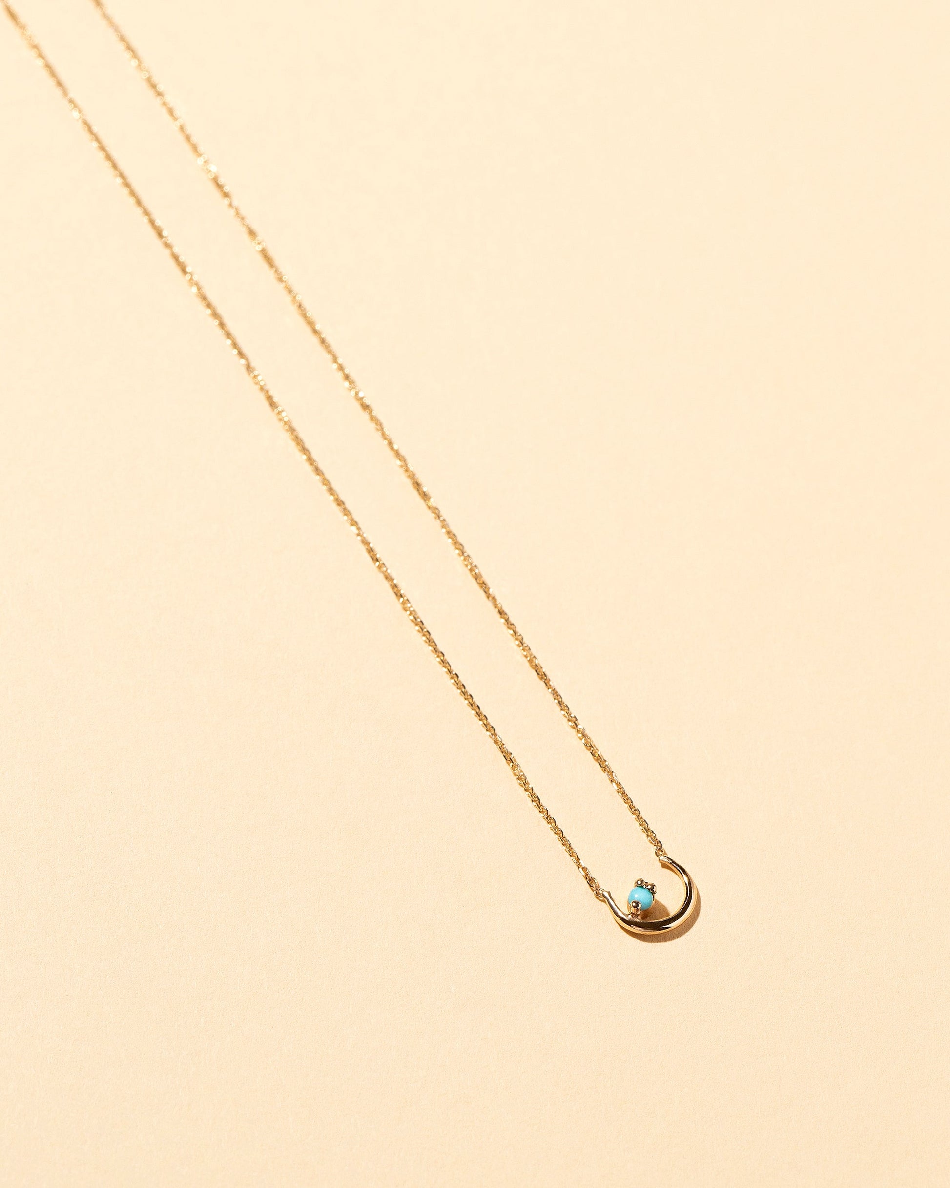 Moon Ray Necklace on light color background.