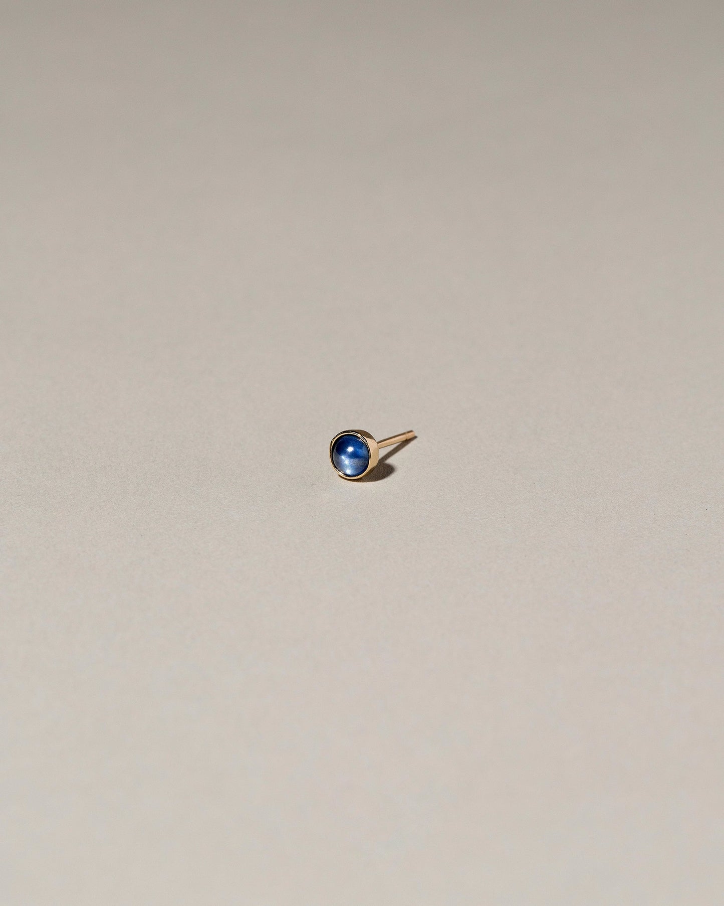Birthstone Single Stud on light color background.