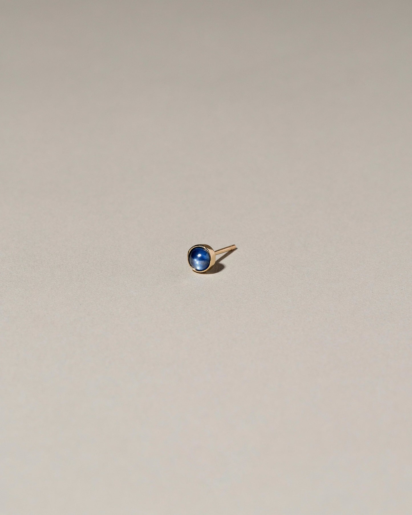  Birthstone Single Stud on light color background.