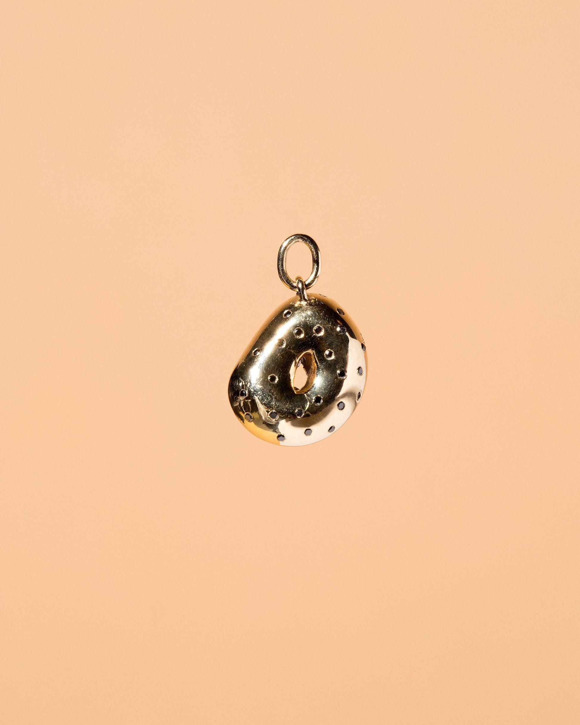 Poppy Seed Bagel Charm with Cream Cheese & Chives on light color background.