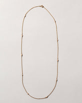 Natural Pink Seed Pearl Necklace on light color background.