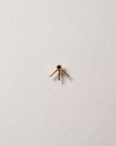 Gold Black Diamond Stud Earring Single on light color background.