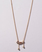 Anthea Necklace on light color background.