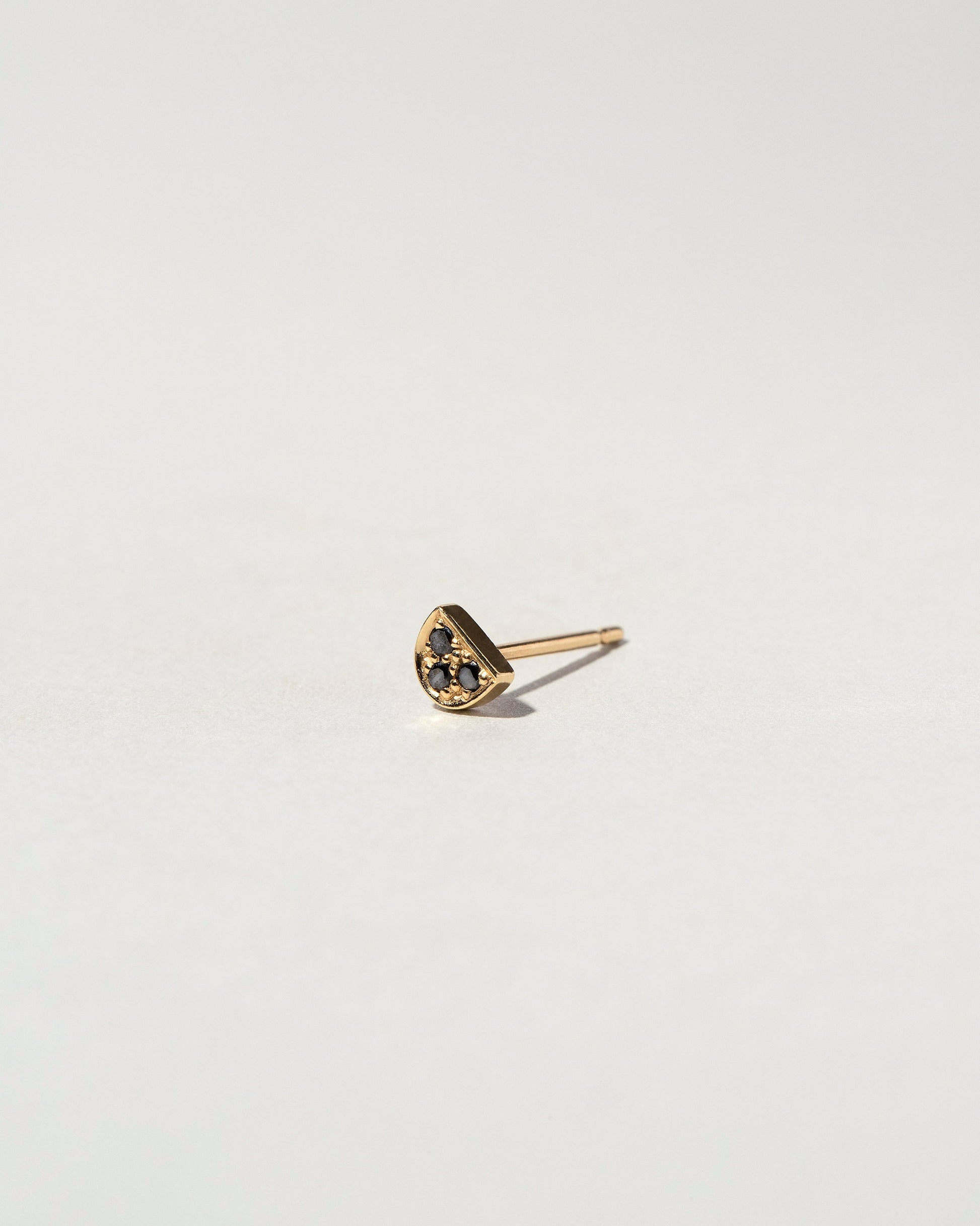 Black Diamond Half Moon Stud Earring Single on light color background.