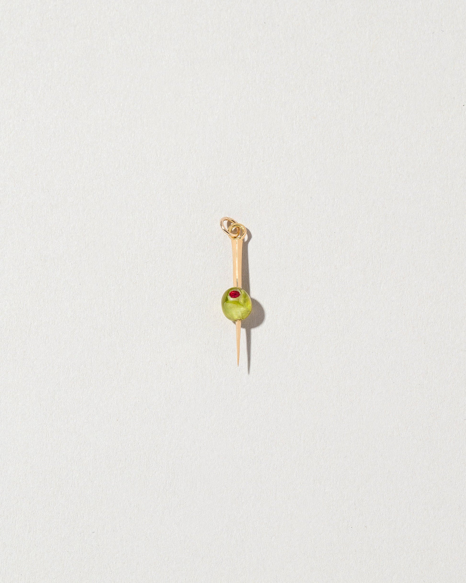 Martini Olive Charm on light color background.