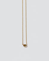 Stand Necklace on light color background.