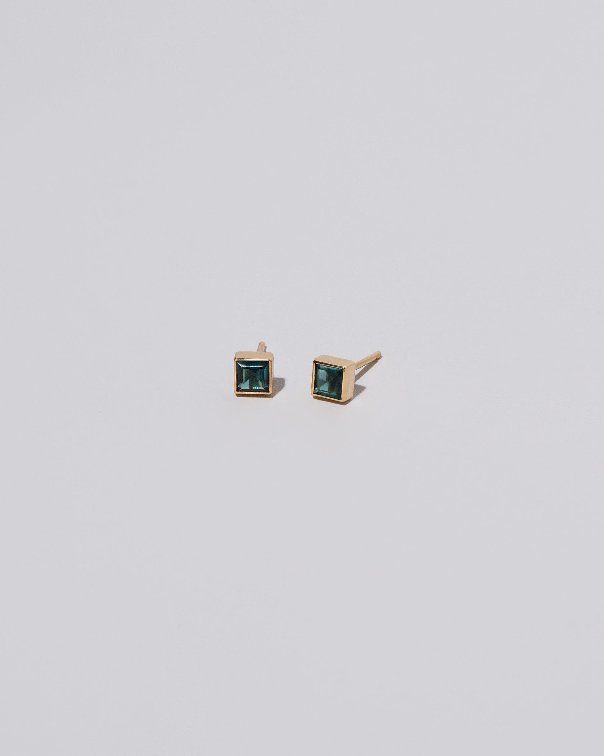 Square Stud - Teal Tourmaline on light color background.