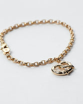 Salted Pretzel Charm Bracelet on light color background.