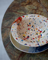 Styled image featuring the La Ceramica Vincenzo Del Monaco Colored Drops First Course Bowl.