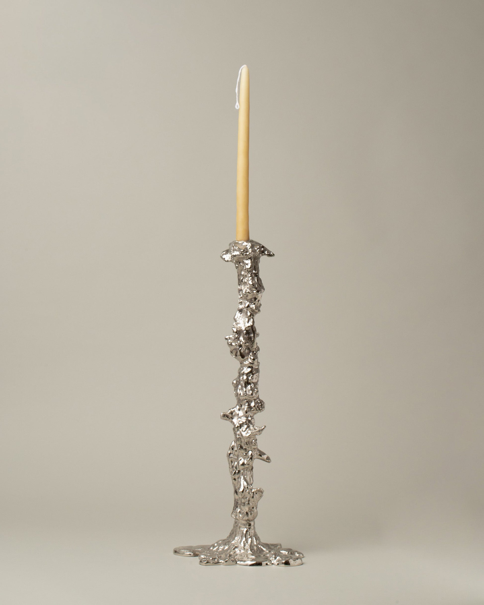 POLSPOTTEN Silver Large Drip Candle Holder on light color background.