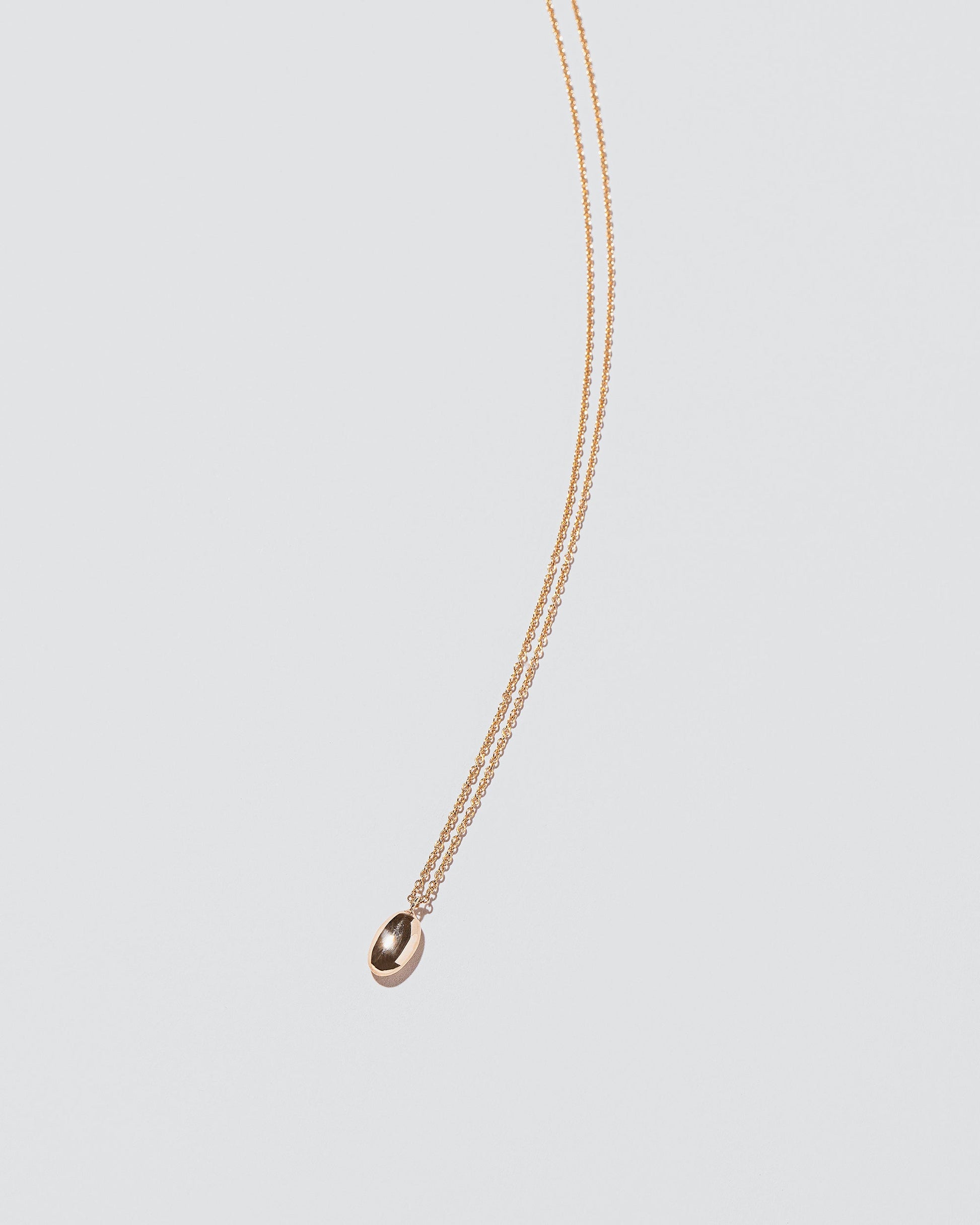 Bead Time Capsule Necklace on light color background.