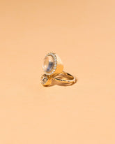 Moonstone & Diamond Cluster Ring on light color background.