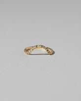 Gold Pavé Blue Sapphire Curve Band on light color background.