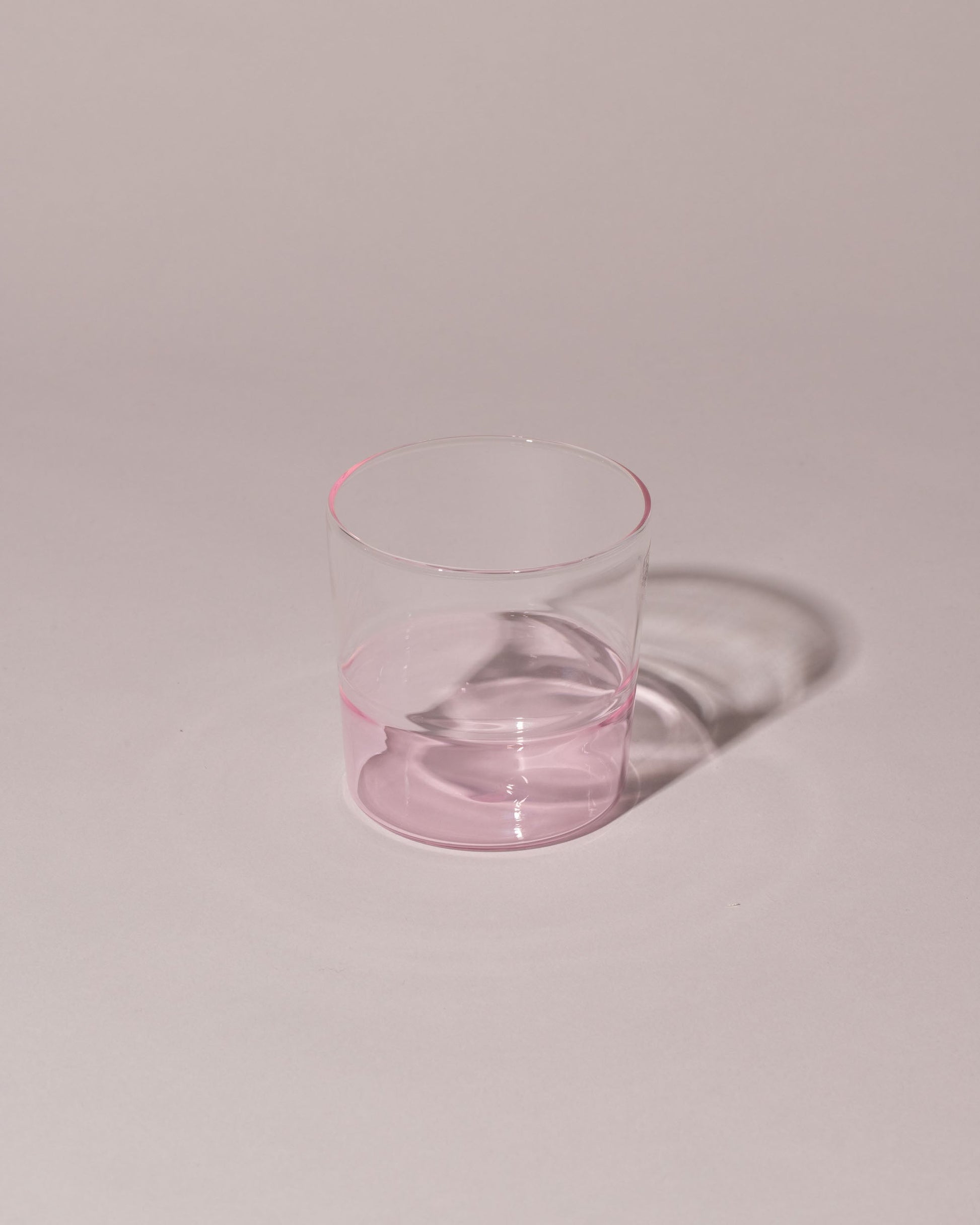 Ichendorf Milano Pink/Clear Light Colore Water Glass on light color background.