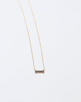 Honokalani Necklace on light color background.