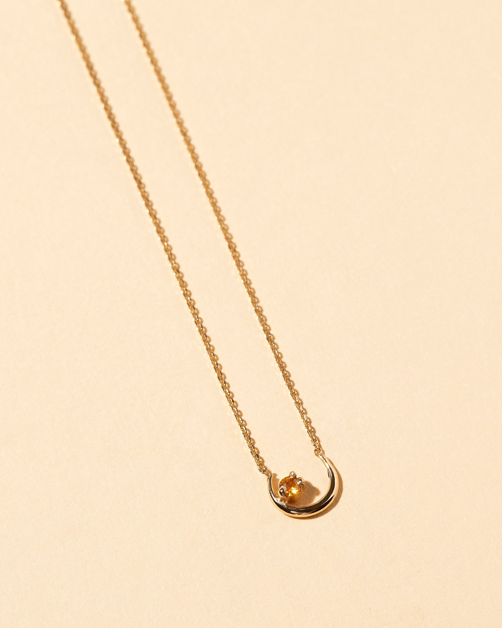Moon Ray Necklace on light color background.