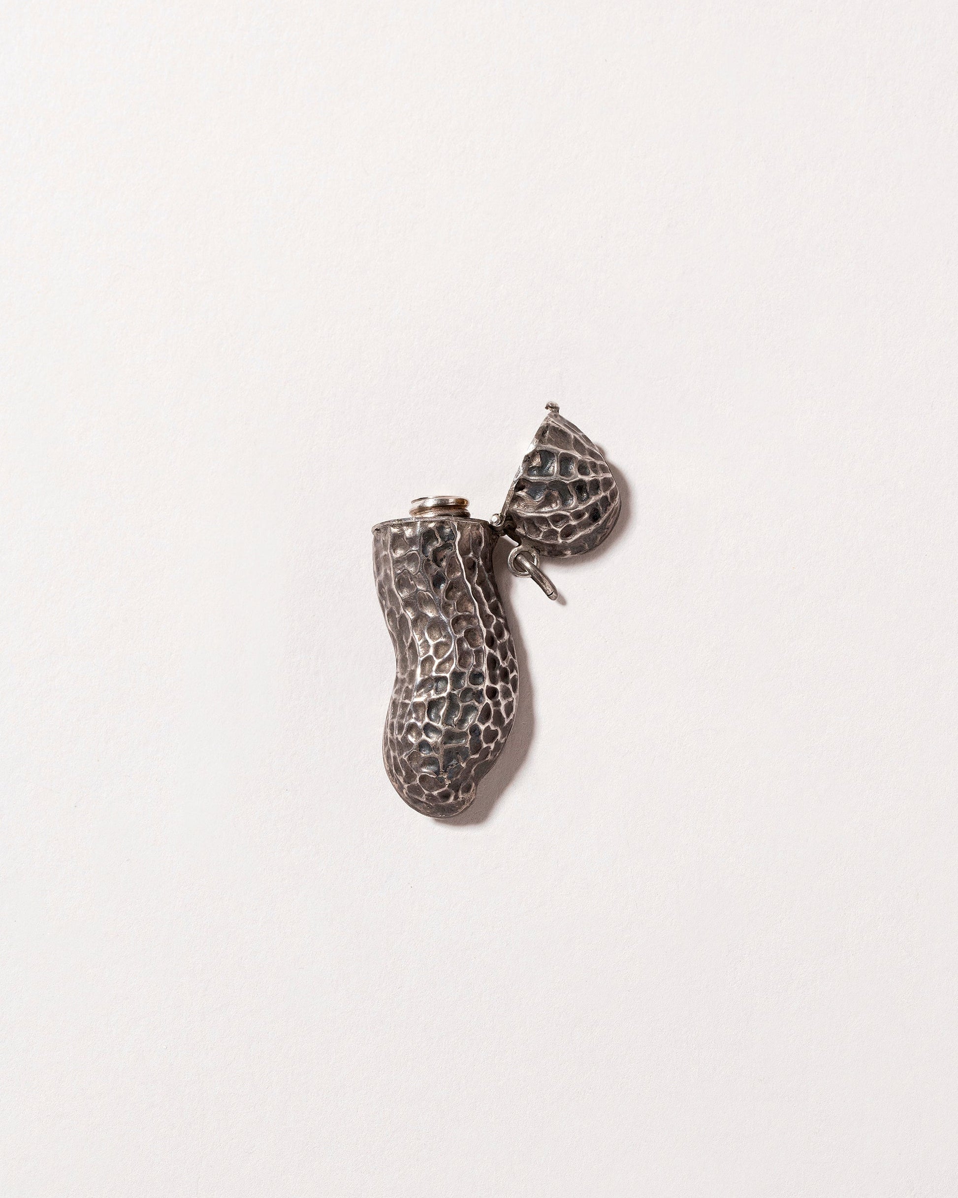 Peanut Atomizer Pendant on light color background.
