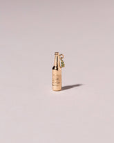 Bottle of Beer Charm on light color background.