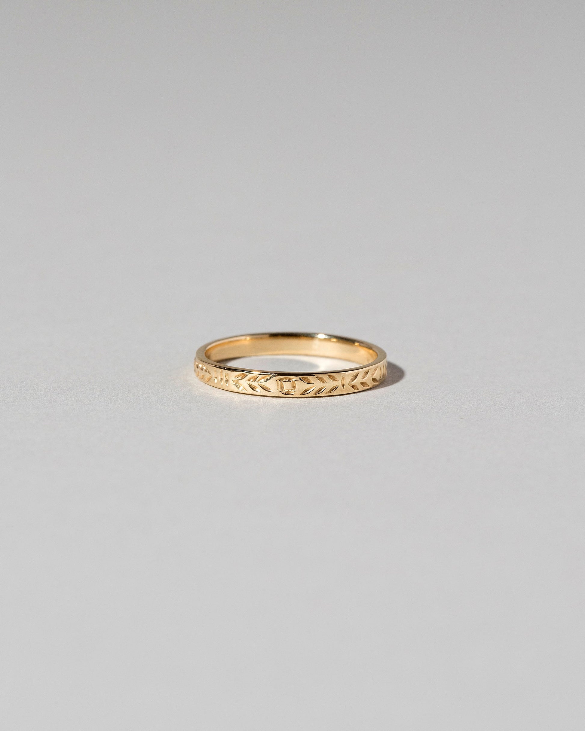 Gold Etched Infinity Pattern Band on light color background.