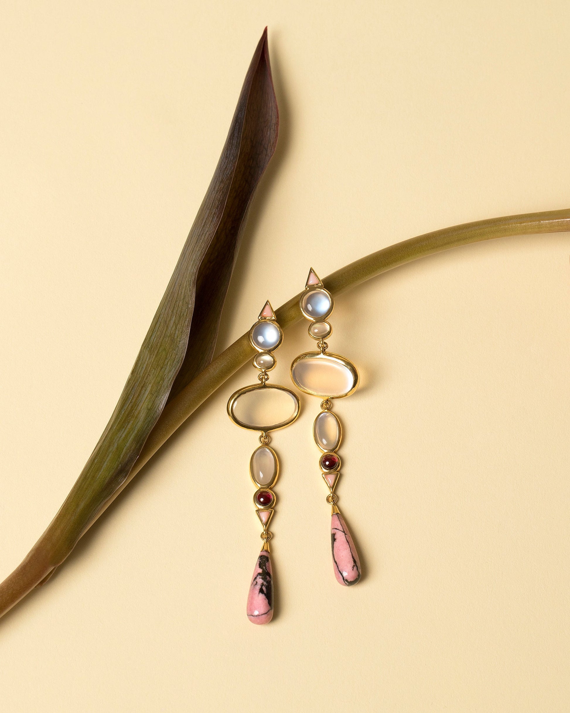 Moonstone & Alaskan Rhodolite Earrings on light color background.