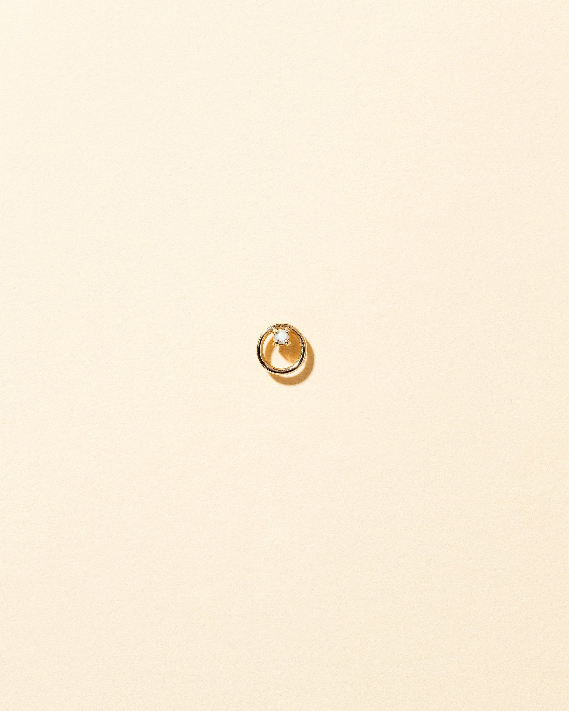 Gold Opal Full Moon Stud Earring Single on light color background.