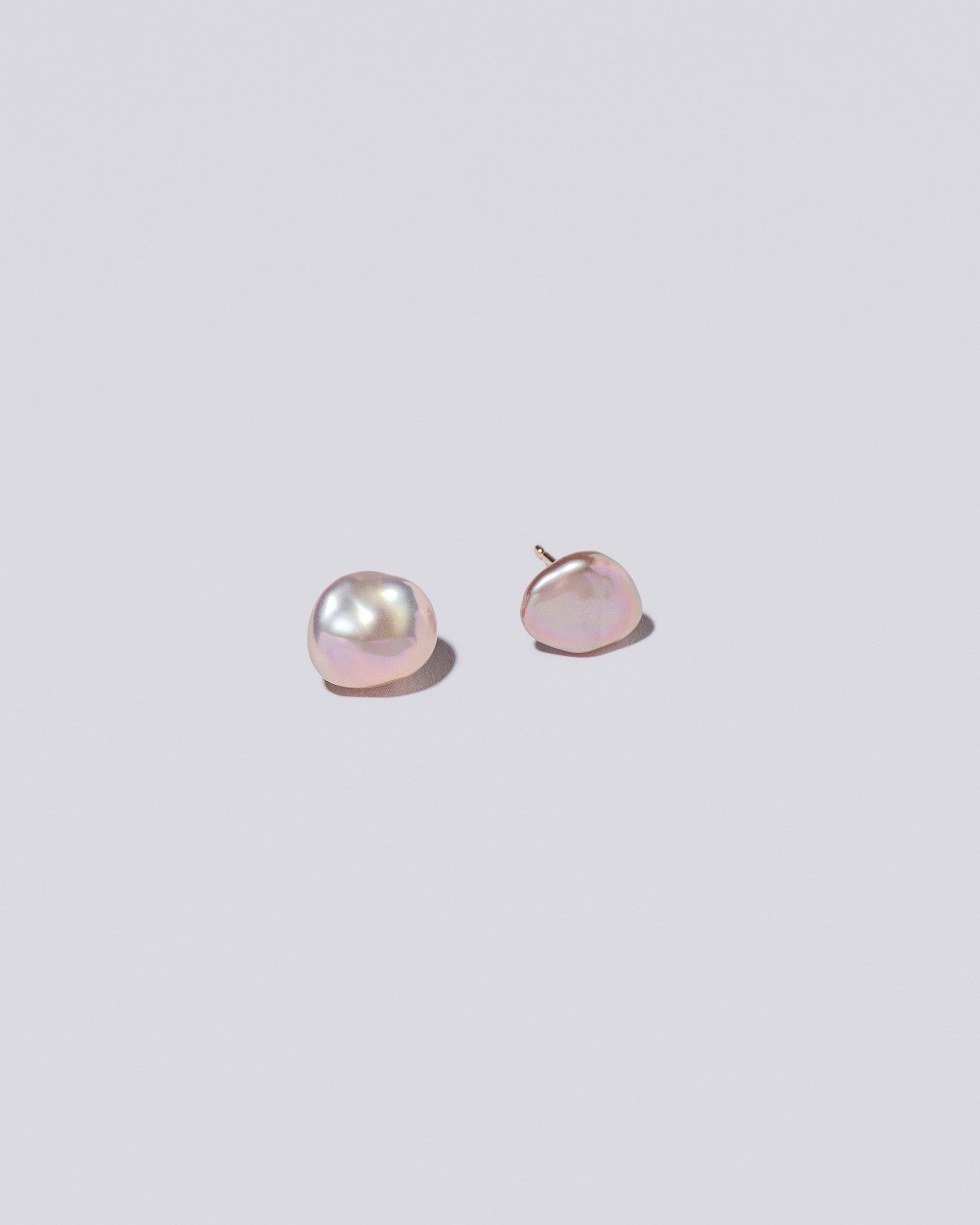 Lagniappe Pearl Stud Earrings on light colored background.