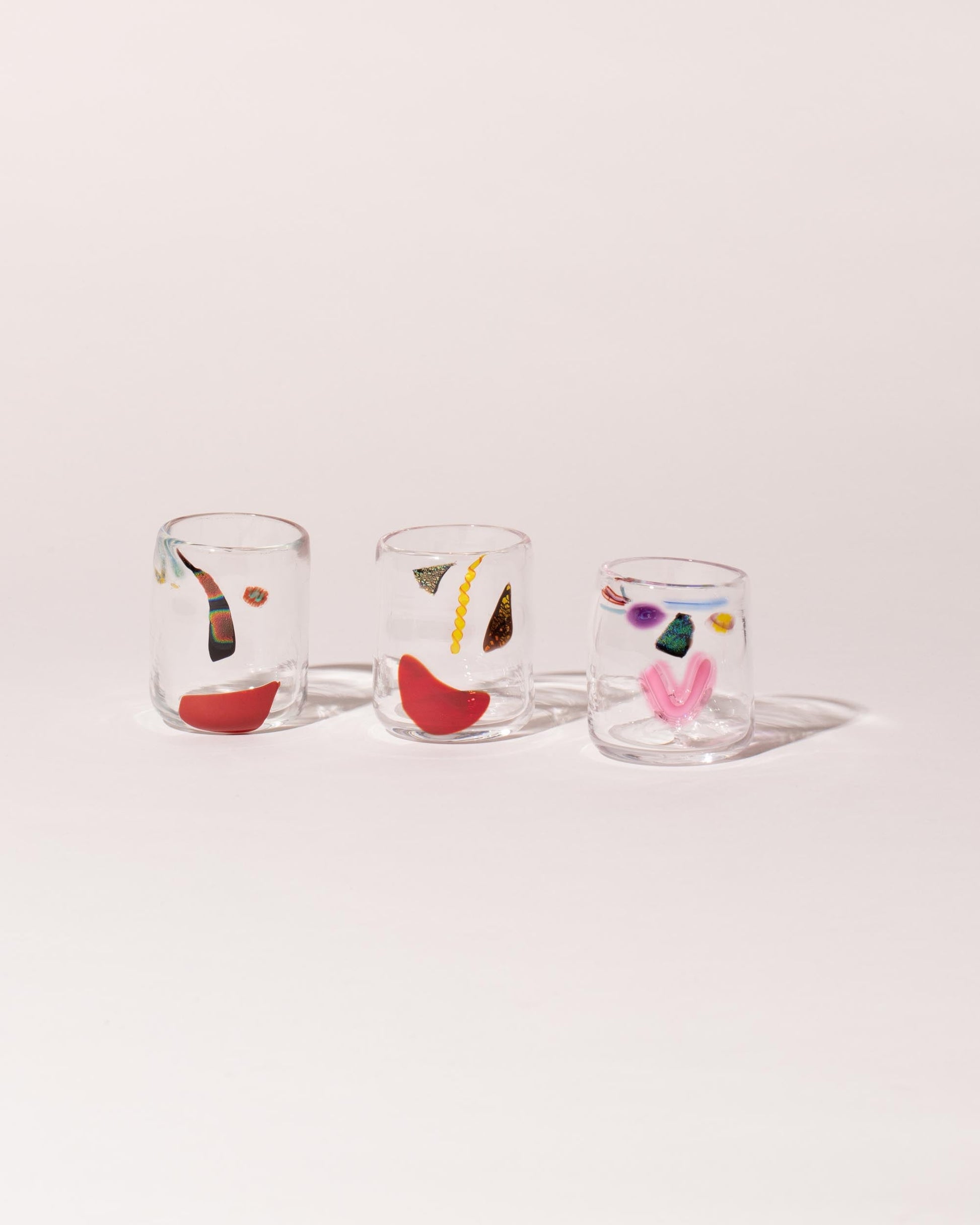 Group of FACEVESSEL Face Glasses on light color background.