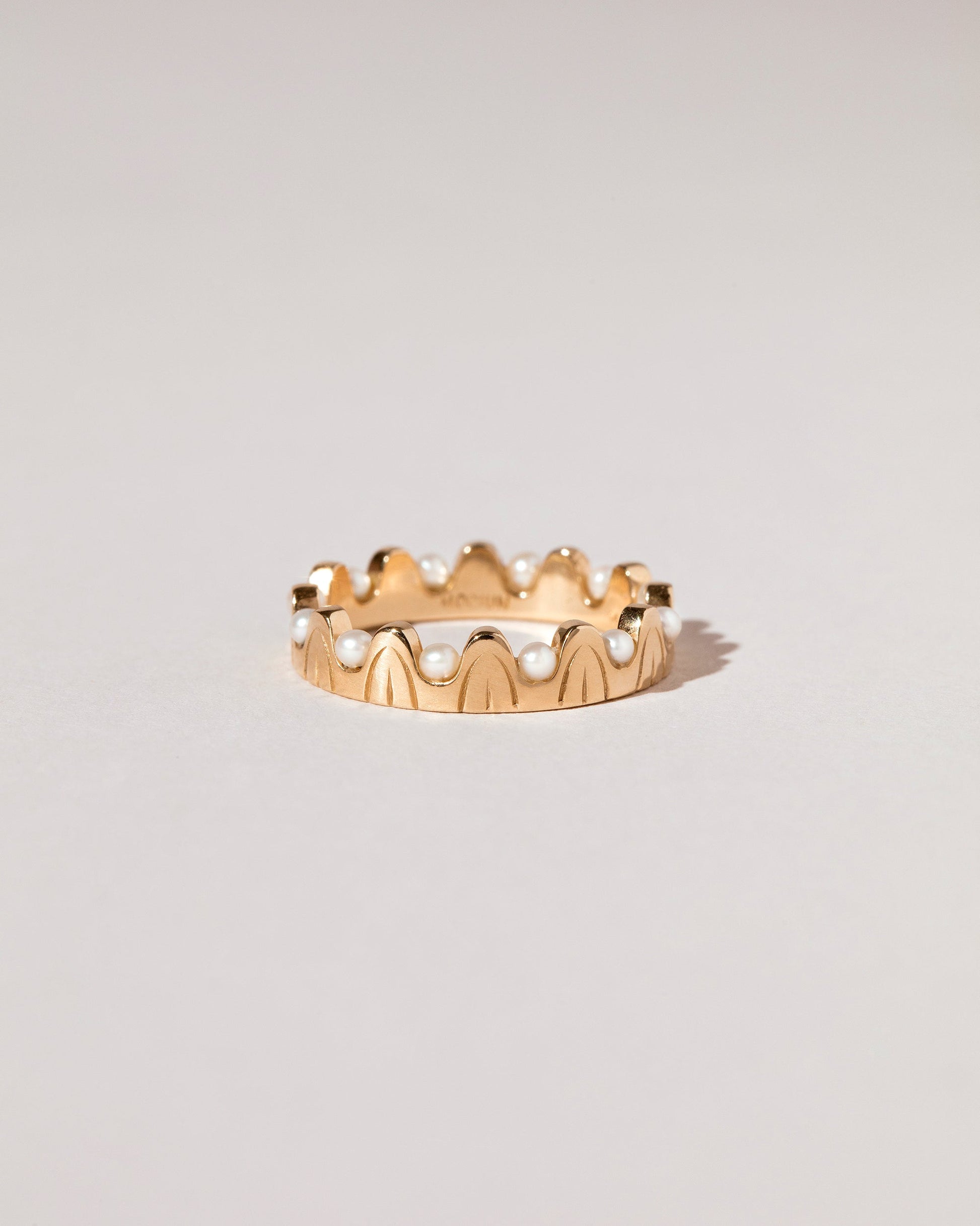 Gold Pearls of Wisdom Band on light color background.