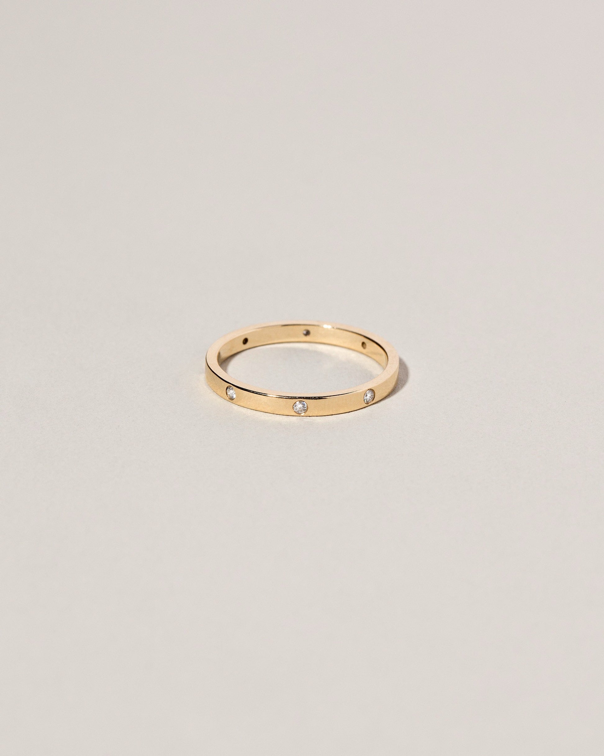 Gold 2mm Square Wire Band with Six Stone White Diamond 1.6mm added on light color background.