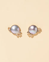 Mabe Pearl Cluster Earrings on light color background.