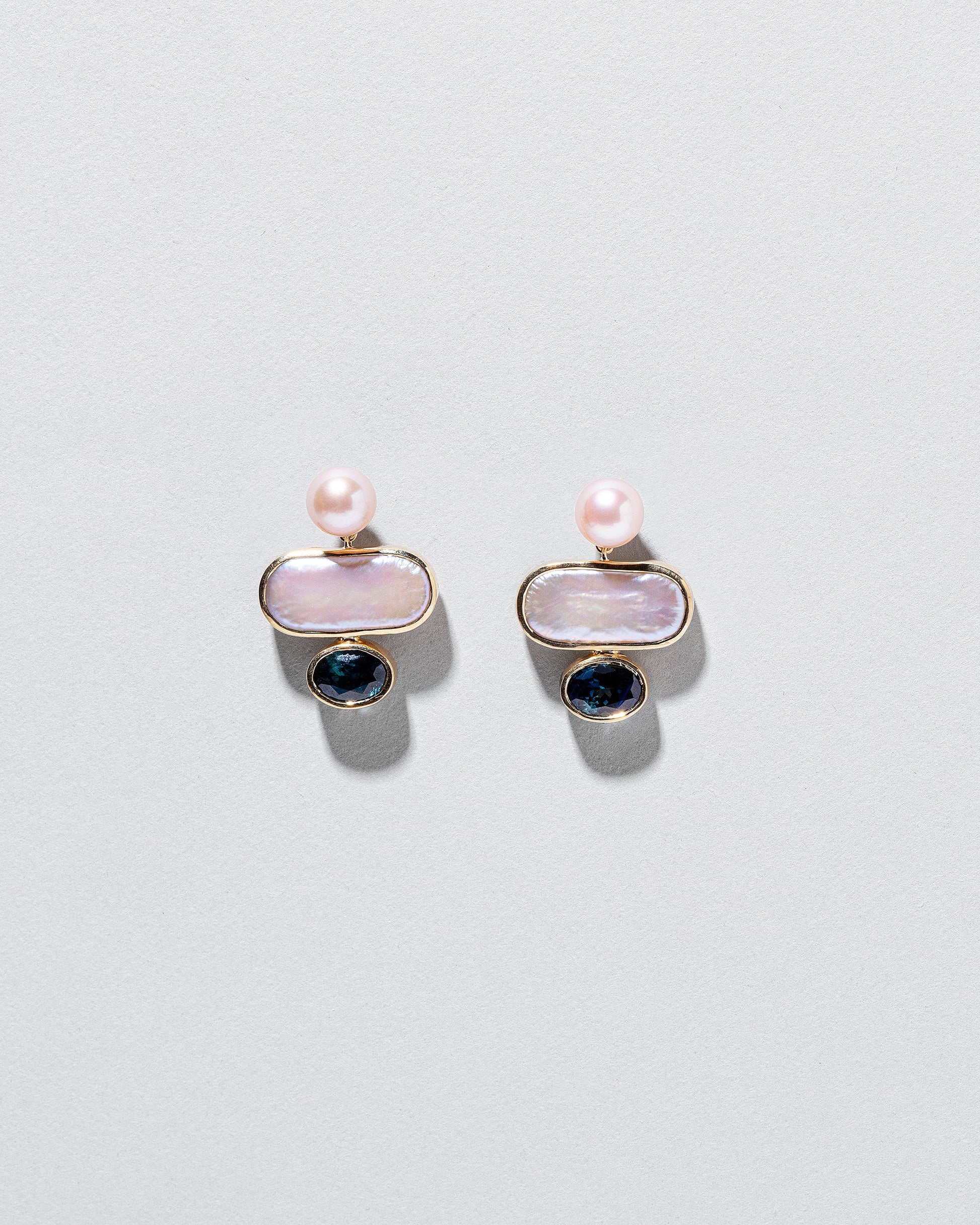 Mantle Earrings on light color background.