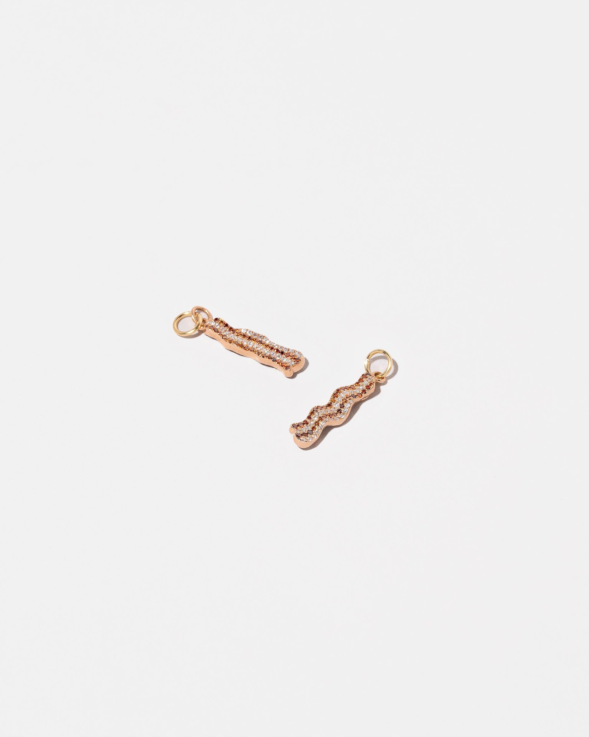 Group of Bacon Charms on light color background.