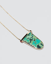 Chrysocolla Tongue Necklace on light color background.
