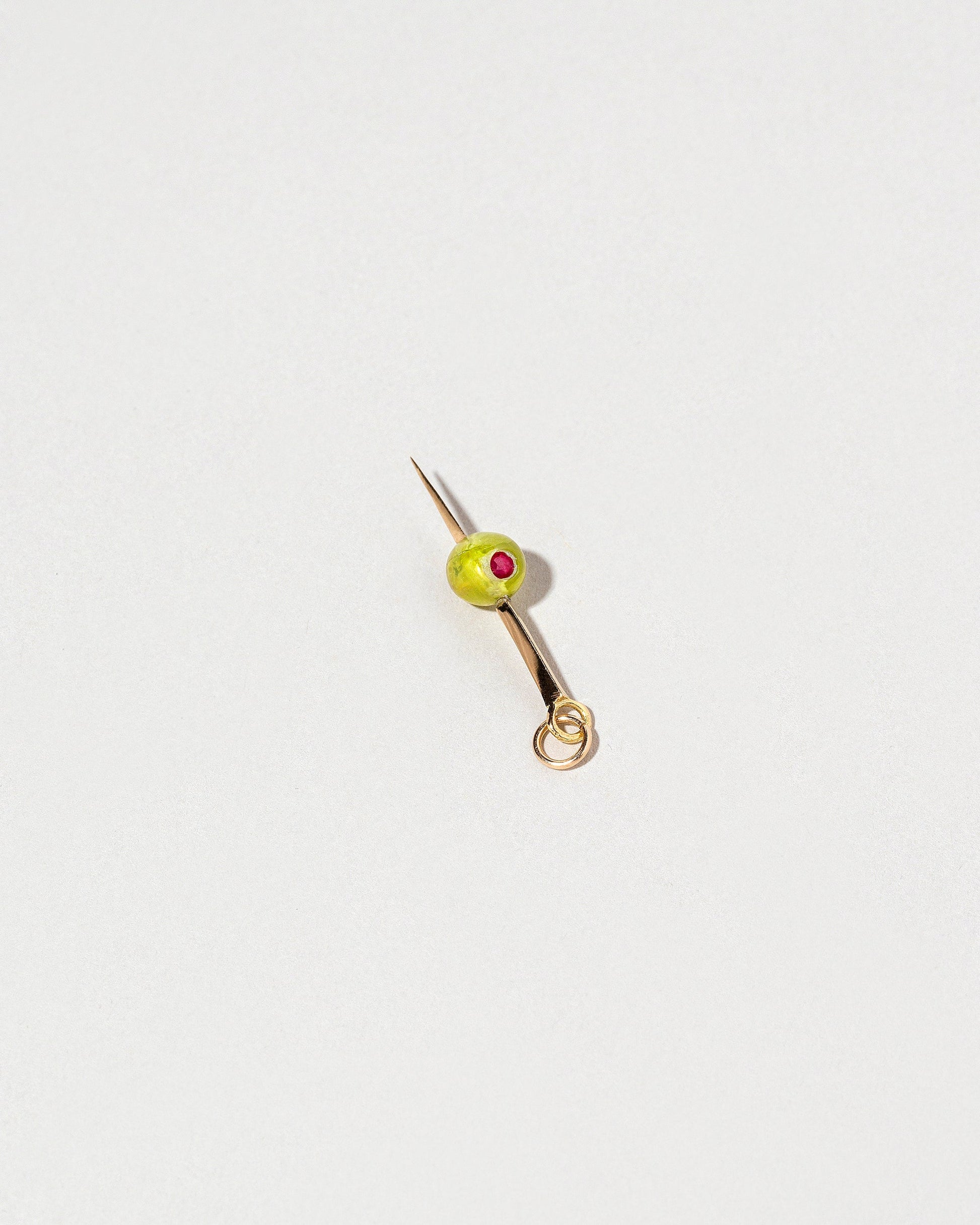 Martini Olive Charm on light color background.