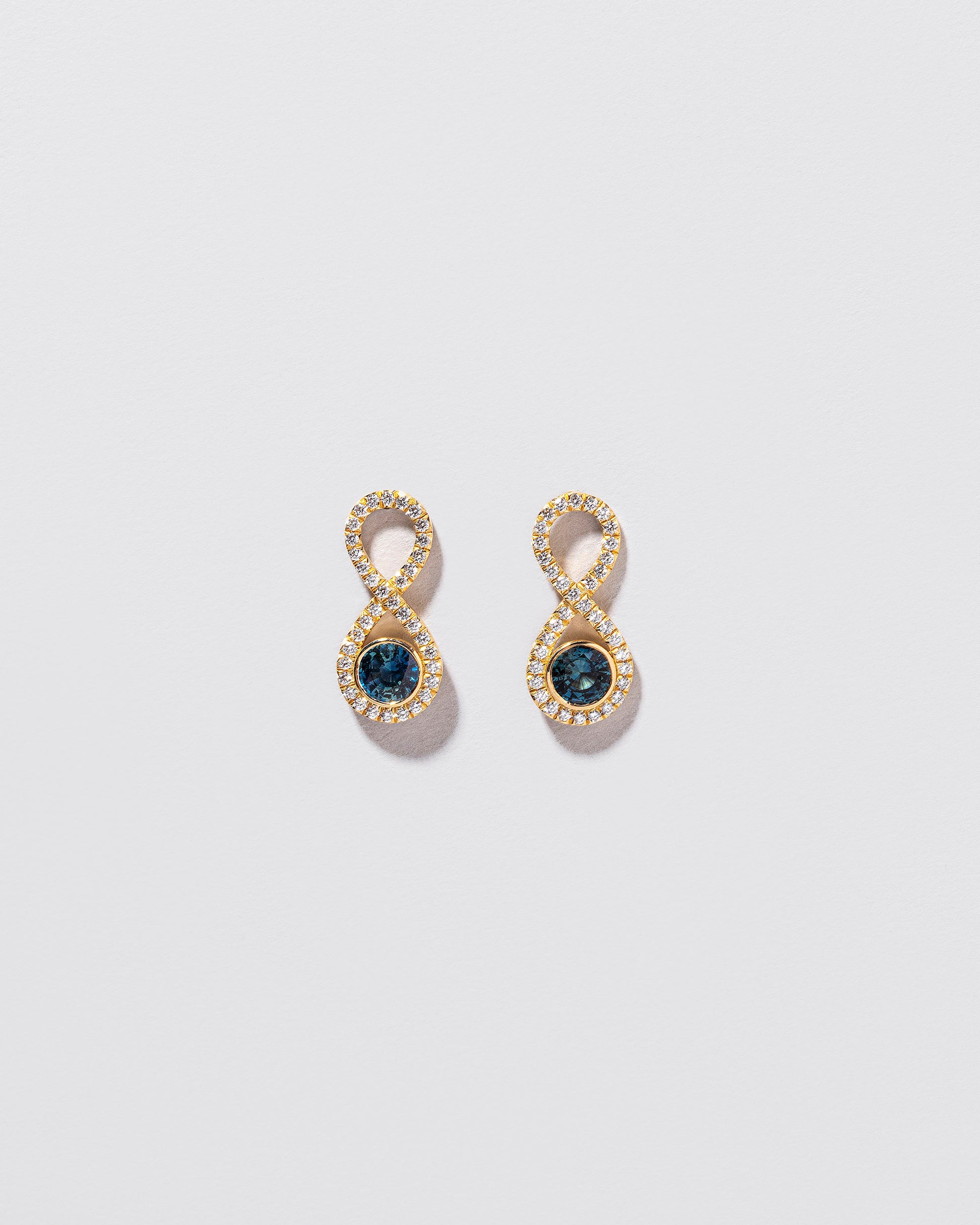 Ouroboros Earring on light color background.