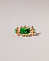 Emerald Lotus Ring on light color background.