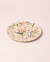 Closeup details of the La Ceramica Vincenzo Del Monaco Colored Drops Large Dish on light color background.
