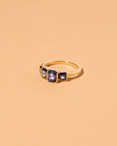 View from the side of the Geometric Sapphire Line Cluster Ring on light color background.