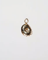 Poppy Seed Bagel Charm with Cream Cheese on light color background.