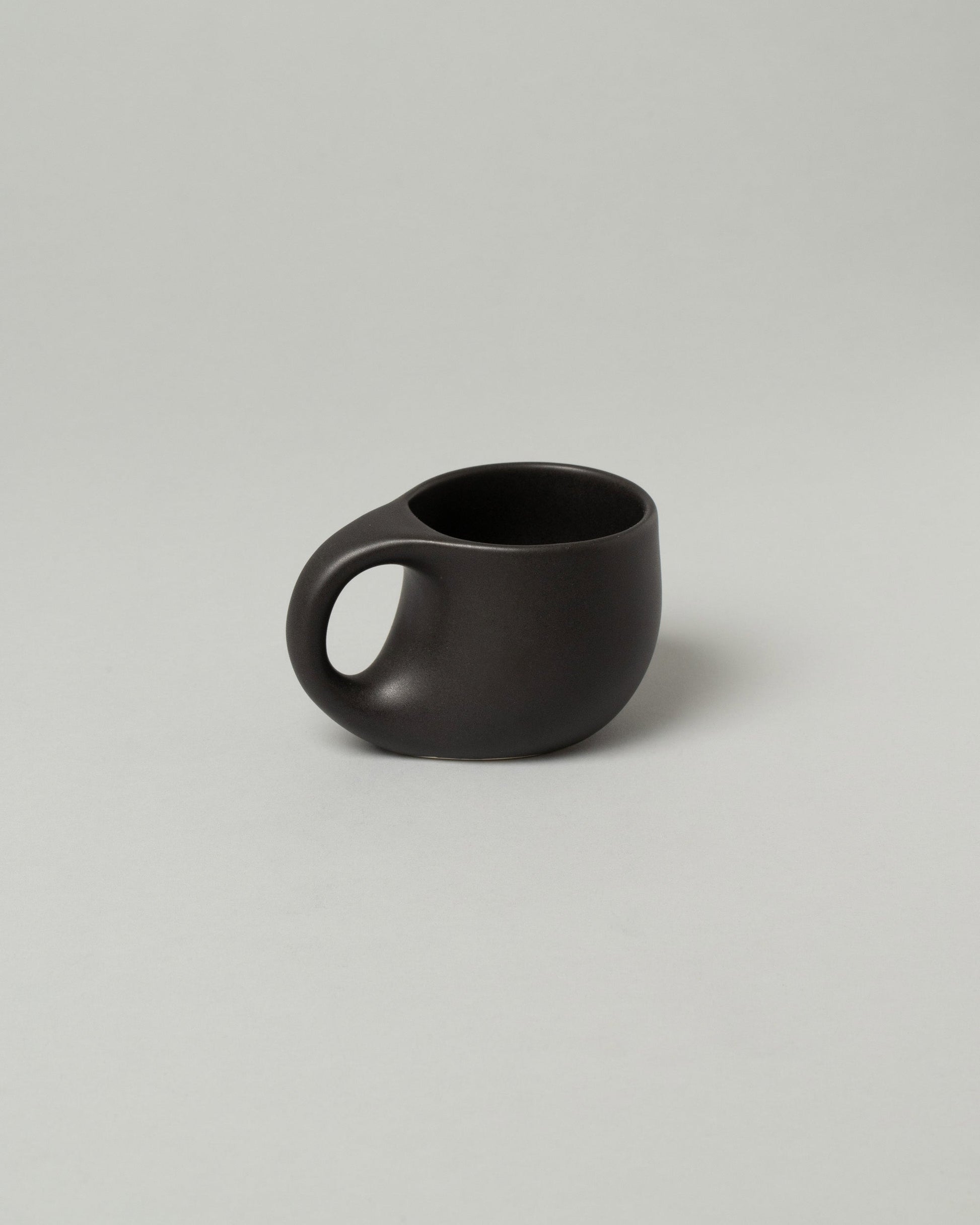 Dust and Form Small Charcoal Comfort Mug on light color background.