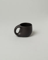 Dust and Form Small Charcoal Comfort Mug on light color background.