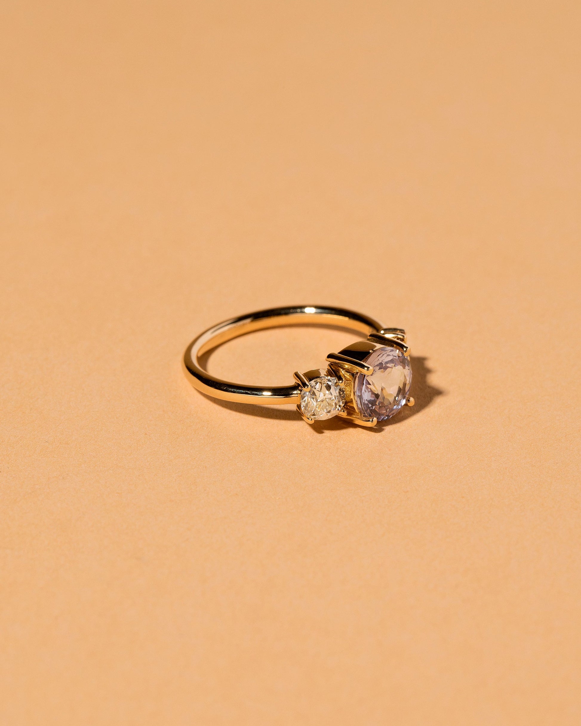 View from the side of the Ratnapura Spinel Line Cluster Ring on light color background.