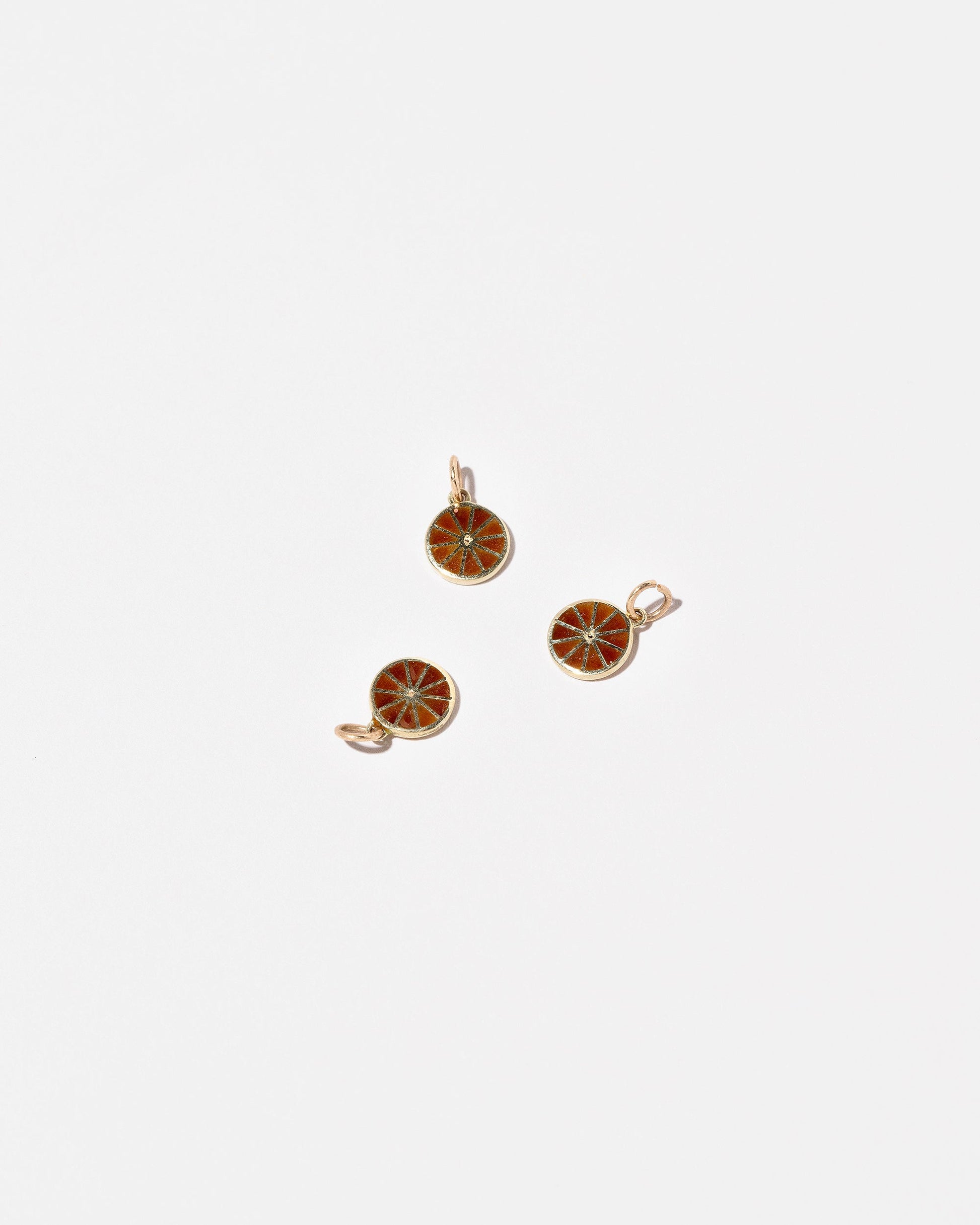 Sliced Fruit Charms - Orange on light color background.