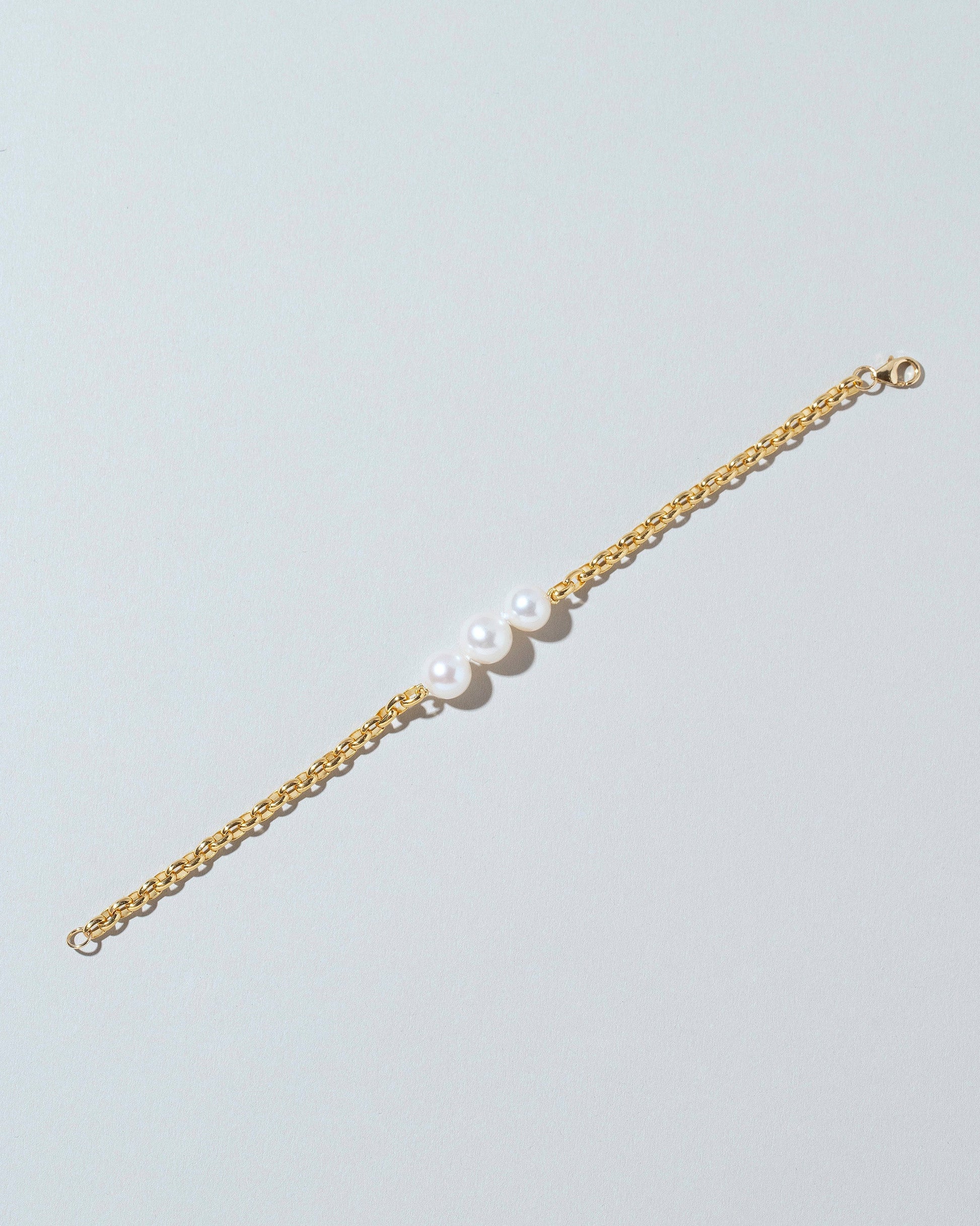 Three Pearl Station Bracelet Short Loop Chain on lightcolor background.