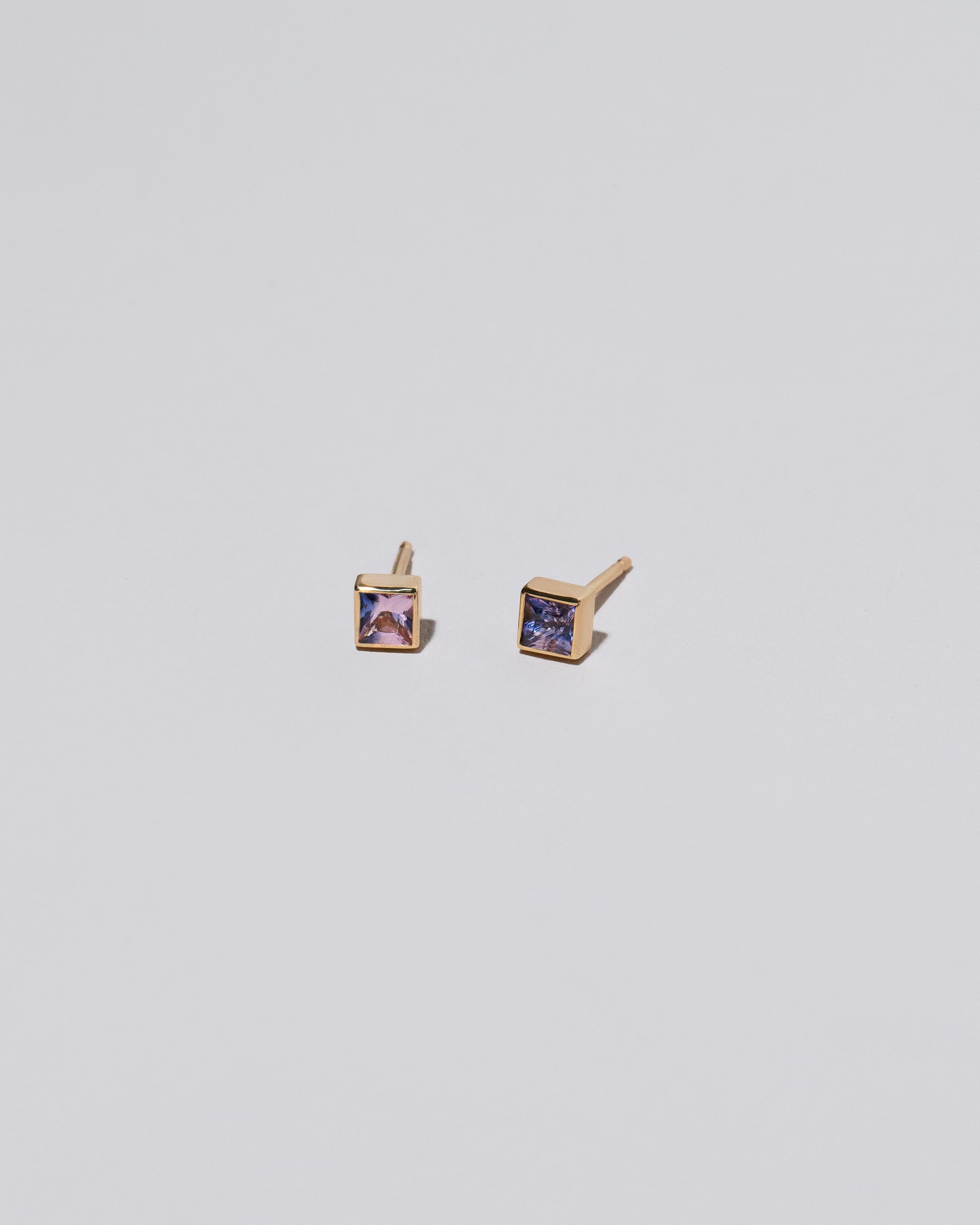 Square Stud - Pink Purple Sapphire on light color background.
