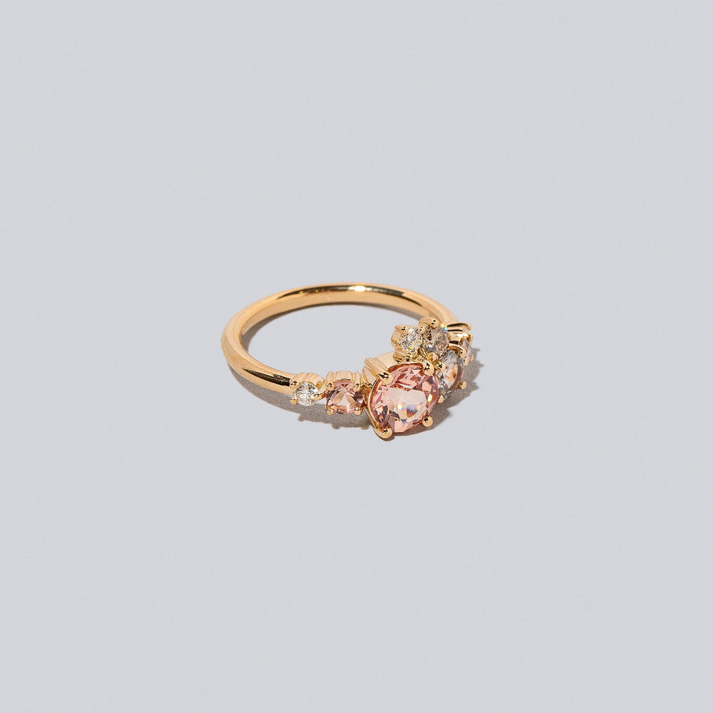 product_details::Lotus Garnet Luna Ring on light colored background.