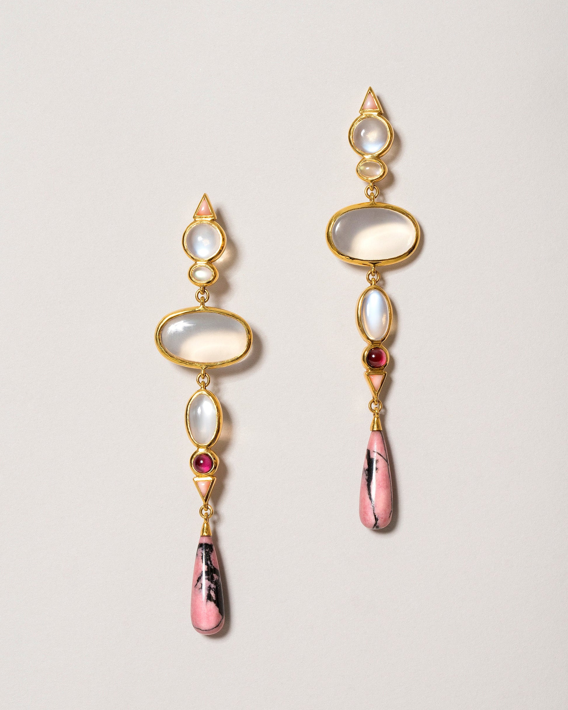 Moonstone & Alaskan Rhodolite Earrings on light color background.