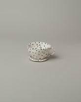 Eleonor Boström Spotty Dog Tea Cup & Saucer on light color background.