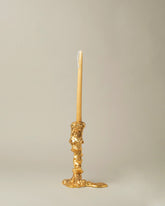 POLSPOTTEN Gold Medium Drip Candle Holder on light color background.